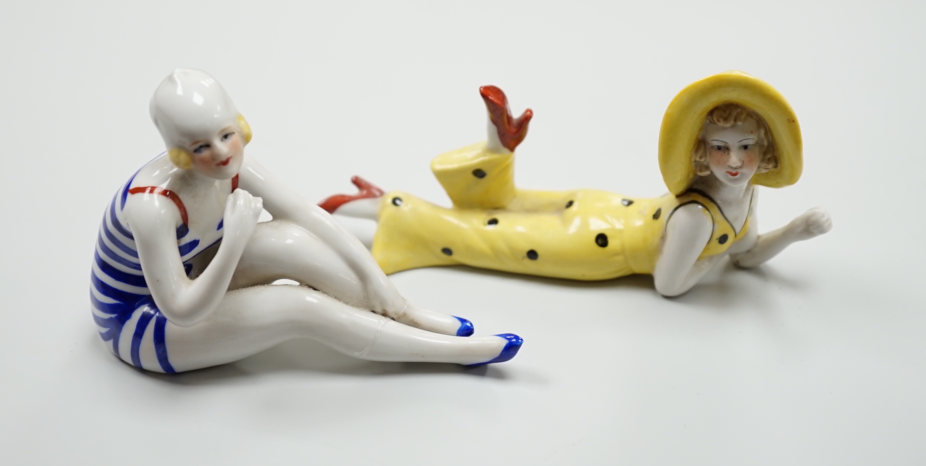 Two German Art Deco porcelain models of bathing beauties, longest 14.5cm